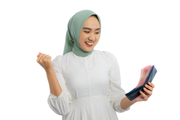 Excited young Asian woman in green hijab and white blouse holding cash in wallet and raising fist up isolated on transparent background