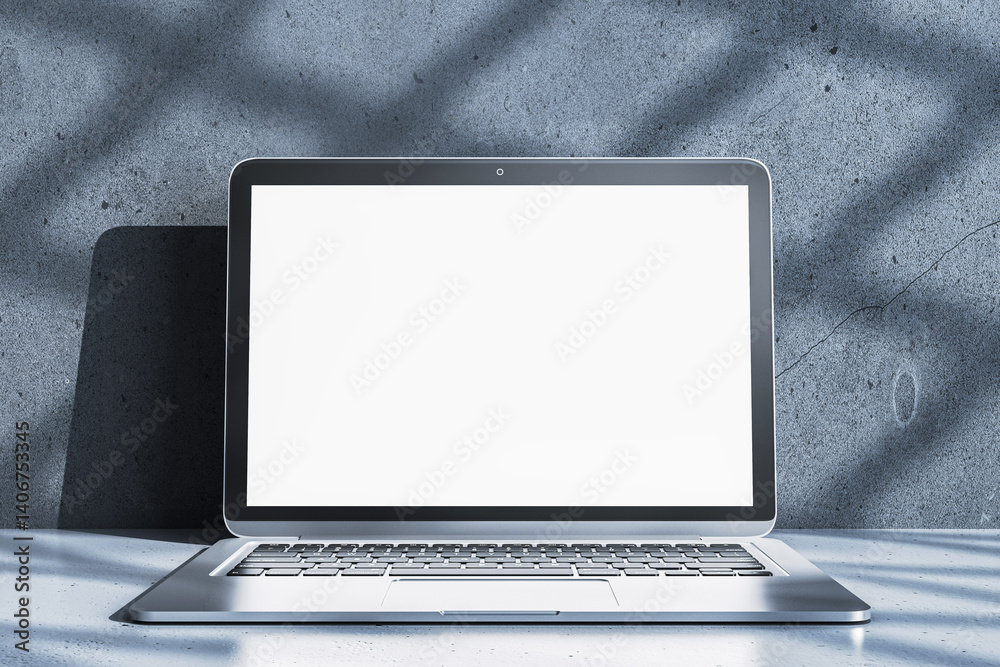 Poster blank laptop screen mockup on concrete desktop surface with sunlight shadows in modern interior room