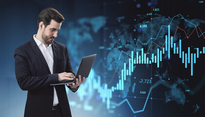 Businessman using laptop with digital financial data charts and global map interface on futuristic technology background in dark blue tones.