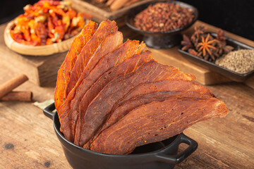 Pork crisps are placed on a wooden table
