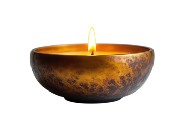 Elegant candle burning in a decorative bowl creating a warm ambiance
