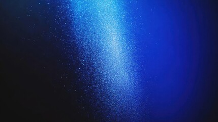 Bright beams of blue light penetrate through water, creating a captivating display of shimmering particles. The tranquil atmosphere enhances the serene beauty of the underwater world