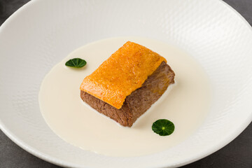 Gourmet beef served with creamy white sauce and crispy topping
