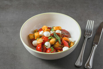 Top view of Italian Panzanella salad on grey stone table