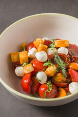Top view of Italian Panzanella salad on grey stone table