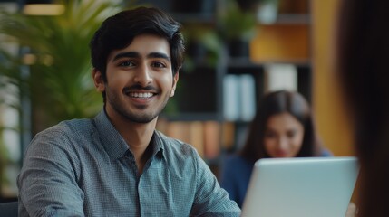 Fototapeta premium Indian happy smiling businessman ceo having working videocall on planning finance with multiracial team colleagues using laptop pc in modern corporation office. Over shoulder view.