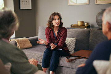 Social worker and advisor talking with senior couple