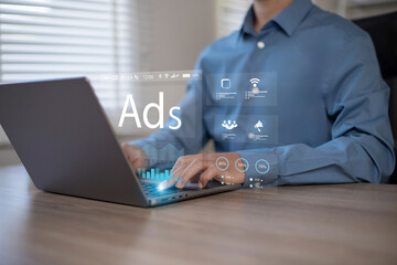 Digital marketing online sales concept. Businessman using laptop with advertising dashboard, promoting product or service through digital channels, search engines, email, website ads and social media.