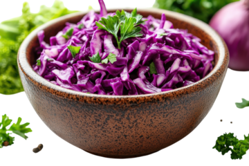 Colorful bowl of fresh purple cabbage salad with herbs on a wooden table