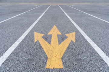 Painted and weathered yellow arrows on a street in Funchal. Disruptive ideas in business with...