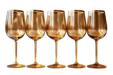 Set of elegant golden wine glasses arranged neatly on a white surface
