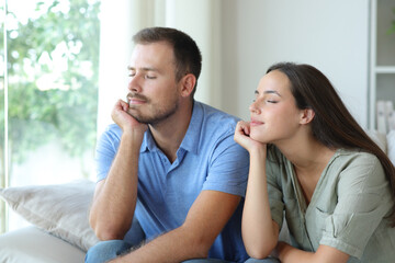 Couple at home relaxing with eyes closed at home
