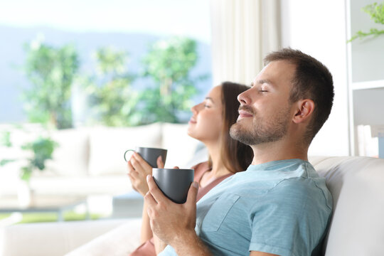 Couple at home relaxing and drinking coffee