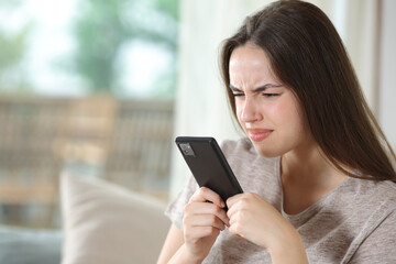 Woman with vision poroblems using phone forcing sight