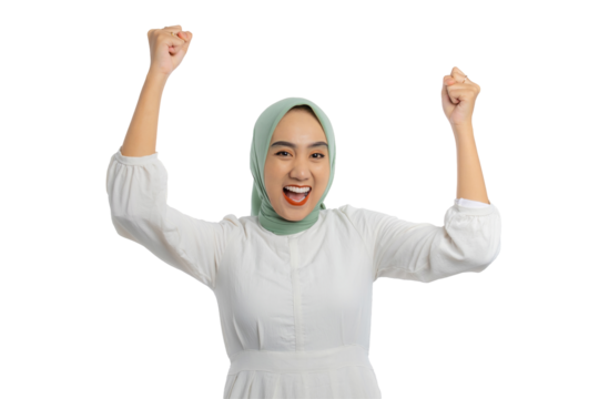 Excited young Asian woman in green hijab and white blouse gesturing yes with raised hand, celebrating victory, success isolated on transparent background