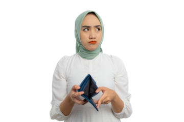 Sad young Asian woman in green hijab and white blouse holding empty wallet and looking aside at copy space isolated on transparent background