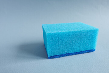 Blue sponges on blue background. Cleaning service concept.