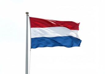Naklejka premium A waving flag of the netherlands on a pole against a bright white sky on a sunny day outdoors