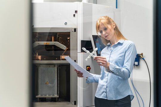 Woman in a laboratory checking a 3D printed object