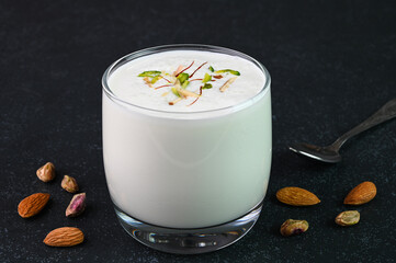 Lassi drink served in a glass cup.