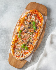 Rustic Mushroom Pizza with Tomato Sauce on a Wooden Board