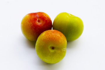 Fresh green plum on white background