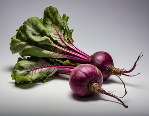Fresh vibrant purple turnips with lush green leaves on a neutral background.