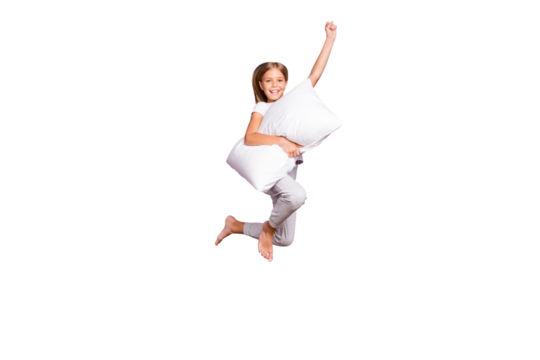 Full length photo of positive cheerful funny kid jump raise fist ahead imagine she strong superhero fly with pillow wear white comfort t-shirt pants barefoot isolated violet purple color background