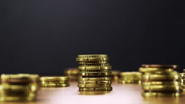 Animated coin stacks reduce one by one in stop motion, symbolizing money loss and decline