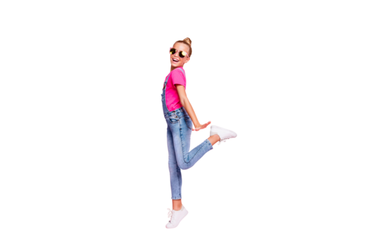 Full length body size photo of funny funky cute nice schoolgirl dancing on her holiday wearing fuchsia t-shirt jeans denim overall footwear isolated over pastel pink color background