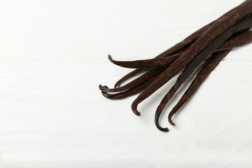 Vanilla pods on a textured background. Vanilla flowers and seeds. vanilla stick bean. Aromatic...