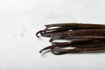 Vanilla pods on a textured background. Vanilla flowers and seeds. vanilla stick bean. Aromatic spicy spice for pastries and desserts. Seasoning. Space for text. Copy Space