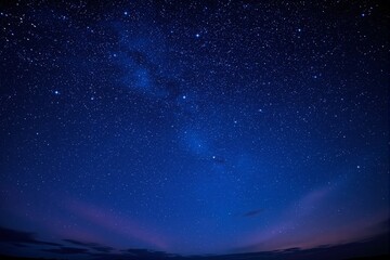 Fototapeta premium Starry night sky with countless bright stars over a dark horizon.