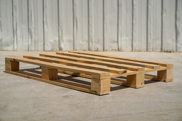 Fototapeta premium Stacked Wooden Pallets in an Outdoor Industrial Setting on a Clear Day