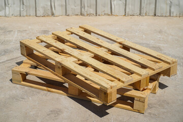 Stacked Wooden Pallets in an Outdoor Industrial Setting on a Clear Day