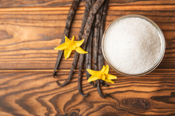 Aromatic vanilla sugar. Vanilla pods. Vanilla sticks, brown and white sugar in a bowl on a textured background. Vanilla flowers, spices and herbs for desserts and baking. Space for text. Copy space