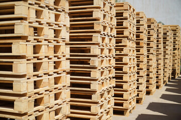 Stacks of Wooden Pallets Vertical Arranged Outdoors in Industrial Factory Setting