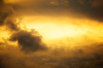 The warm tones of sunset dance across the sky, with delicate clouds adding a touch of whimsy to the scene.