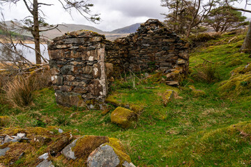 Derelict small stone building on lake shore