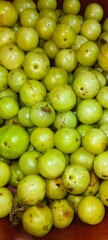 a close-up view of a bunch of Indian gooseberries, also known as Amla