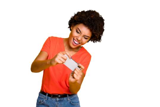 Photo of addicted attractive gaming girlfriend trendy playing some games on her phone wearing jeans denim isolated over yellow vivid color background