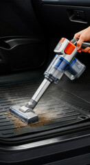 Cleaning car interior with handheld vacuum in a vehicle during daytime
