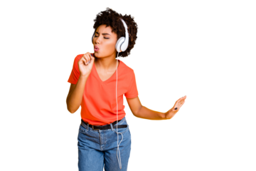 Photo of cheerful charming attractive nice cute curly wavy trendy black afro american girlfriend wearing jeans denim t-shirt singing wearing headphones isolated bright color yellow background