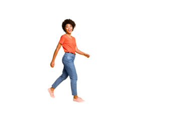 Copyspace photo of charming nice attractive beautiful girlfriend wearing jeans footwear going towards something while isolated over yellow vibrant color background