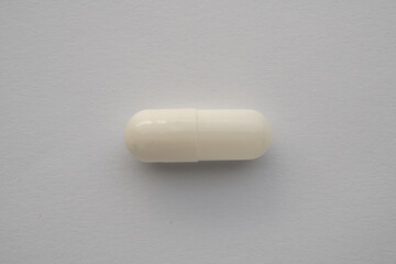 White medicine pill capsule on white background