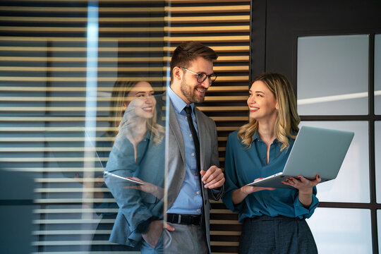 Business professionals collaborating on a project in a modern office. Team of coworkers sharing idea