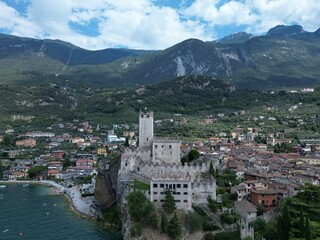 Naklejka premium Drone Flight Over Malcesine Village and Historic Castle on Lake Garda