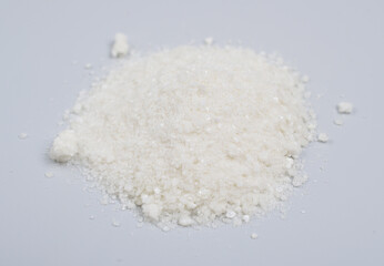 Sodium diethyldithiocarbamate powder on the light gray background