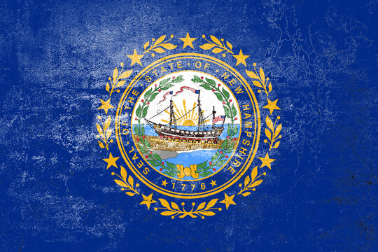New Hampshire State Flag. Dirty New Hampshire state flag on the wall.