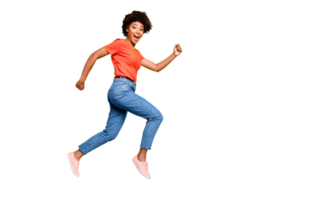 Full size photo of excited amazed girl jump run after sales discounts scream wow omg wear red t-shirt denim jeans sneakers isolated over yellow color background